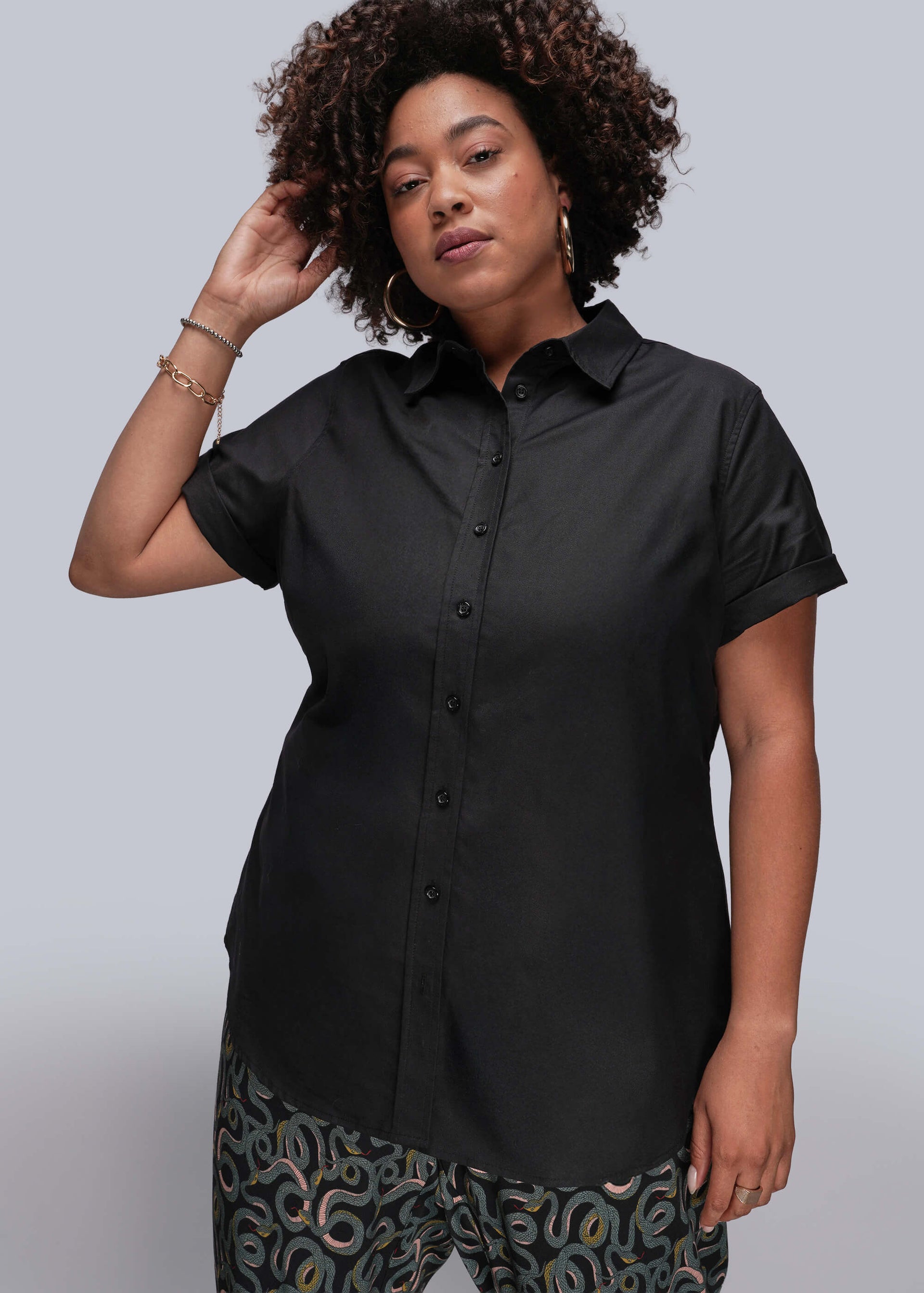 1X=Person wearing a black short-sleeve shirt against a gray background