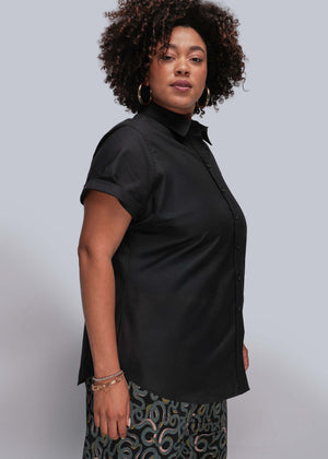 1X=Person wearing a black short-sleeve shirt against a plain background