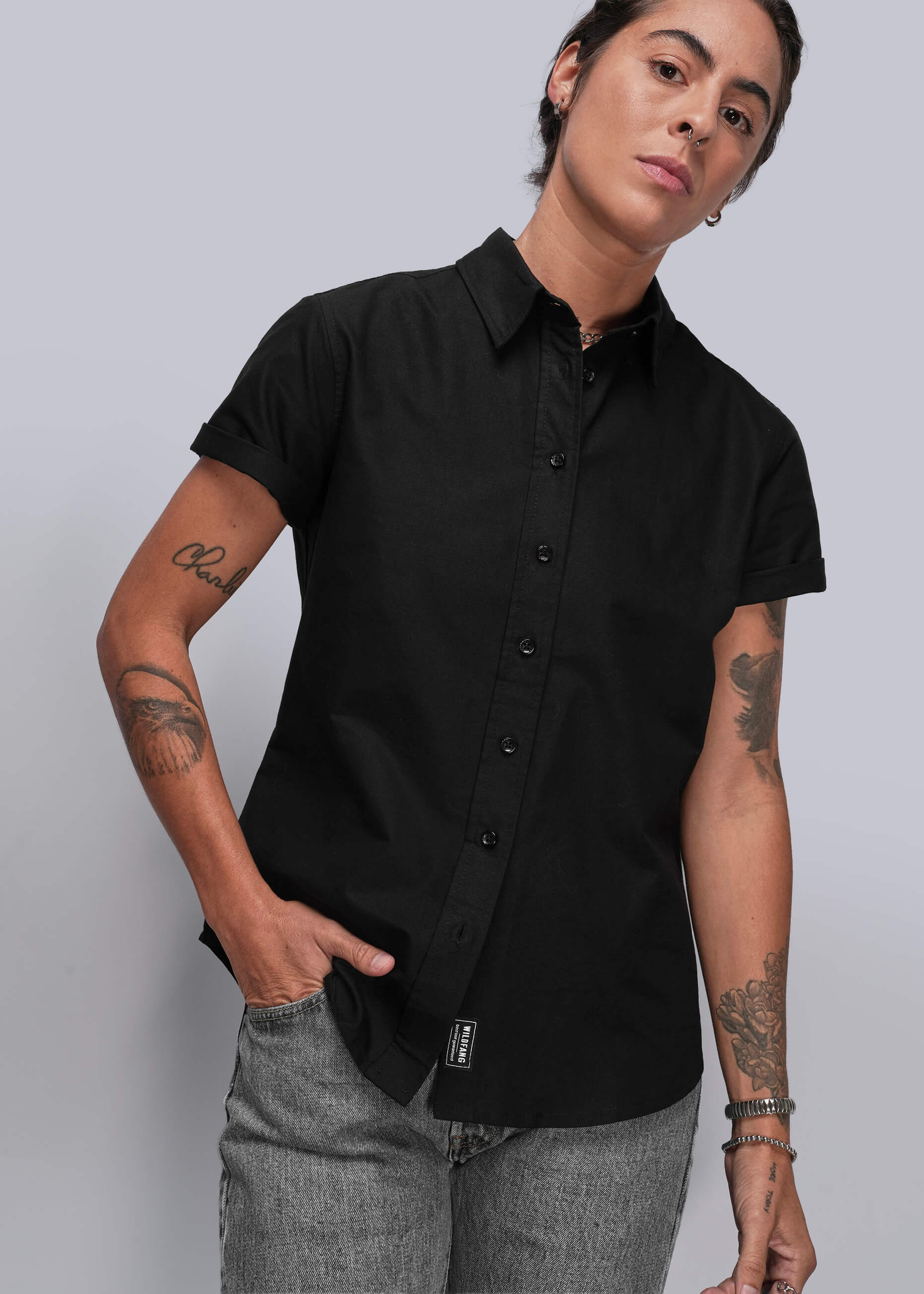 S=Person wearing a black short-sleeve shirt against a plain background