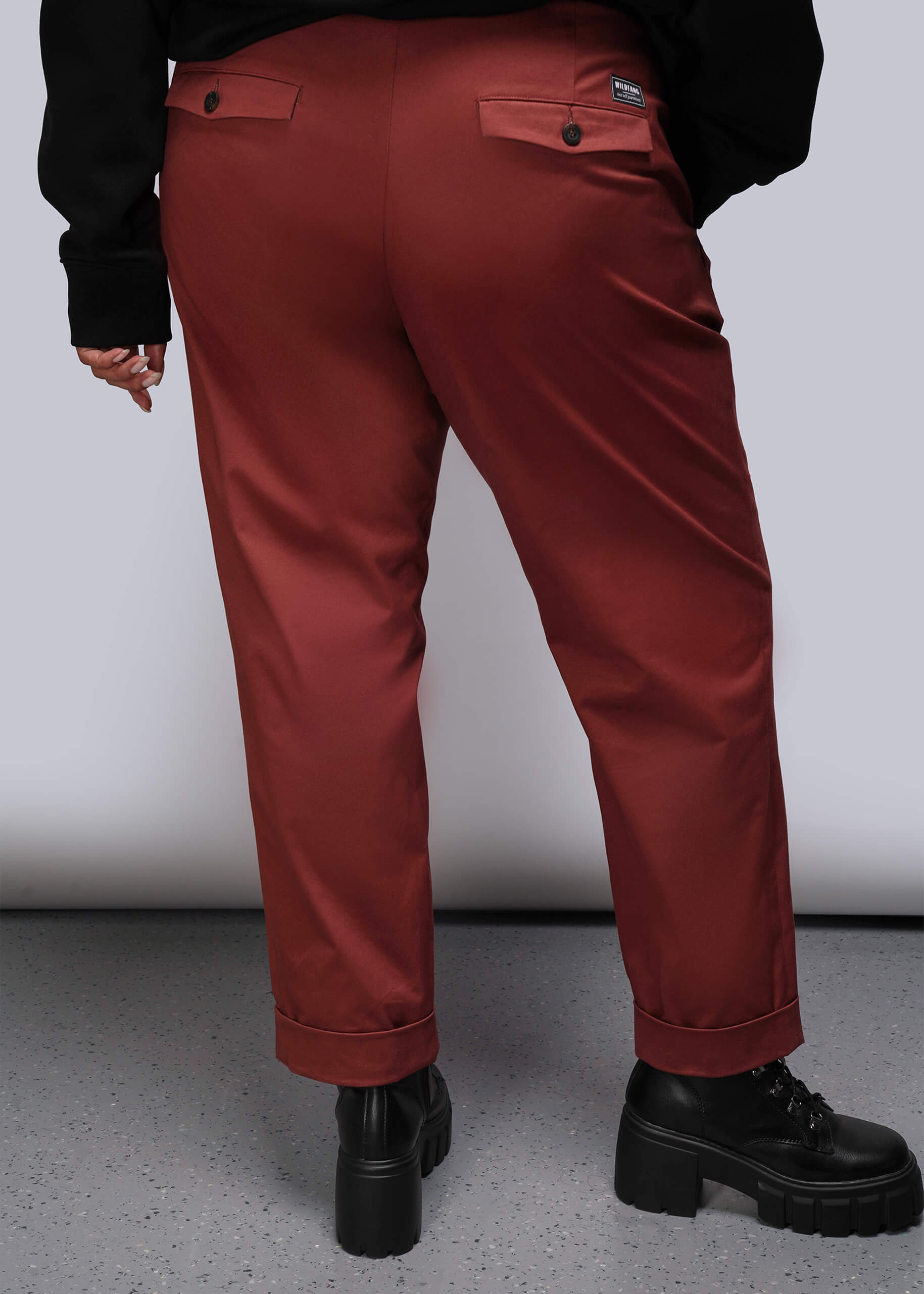 1X=Red orange pants worn by a person on a plain background pictured from the back
