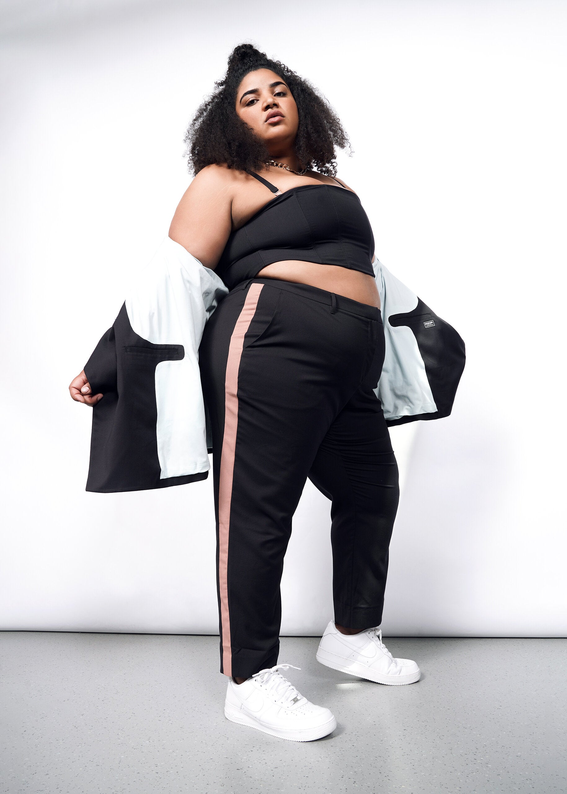 Model wearing The Empower Colorblock Slim Crop Pant in Black/Rose Brown