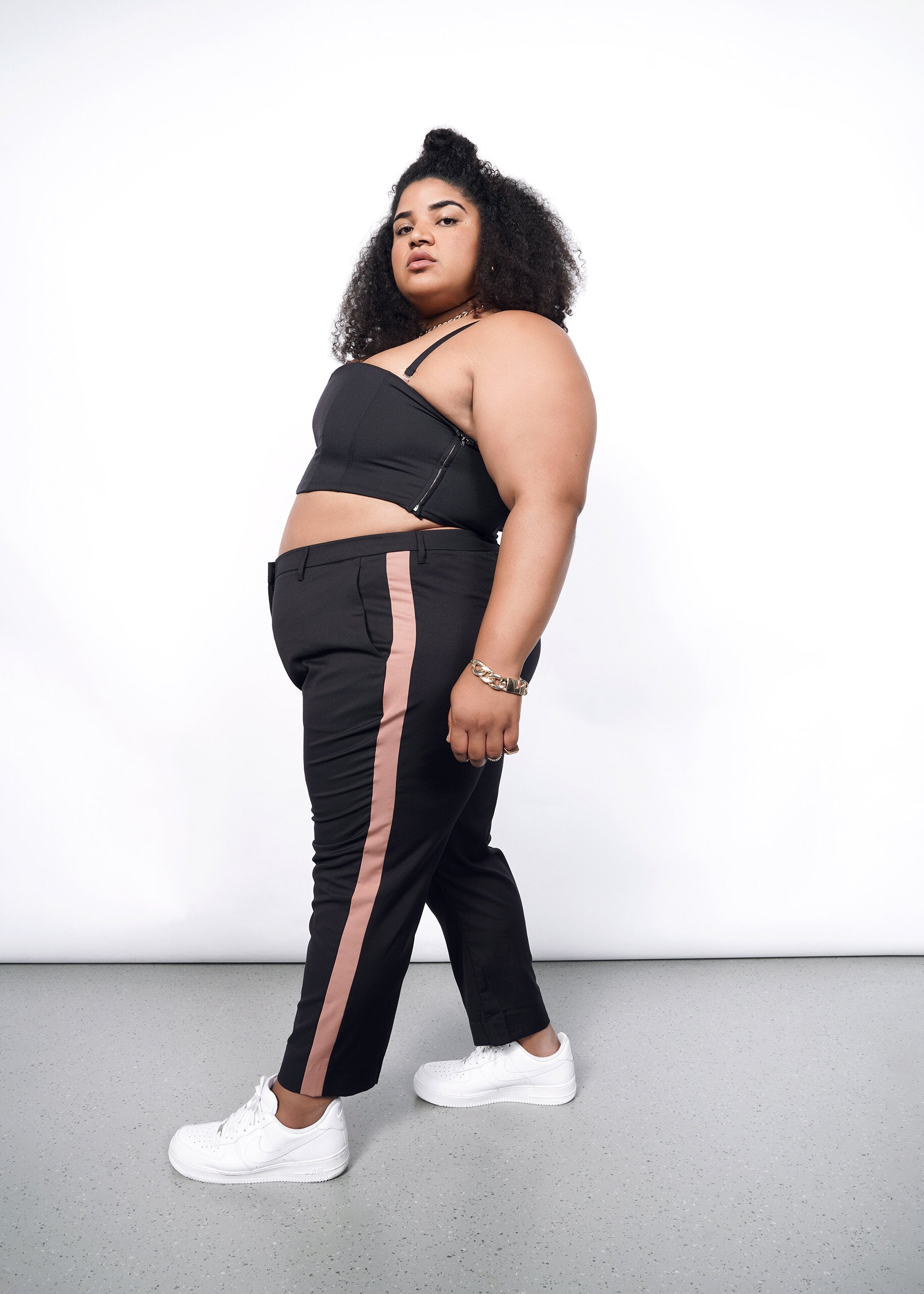 Model wearing The Empower Colorblock Slim Crop Pant in Black/Rose Brown