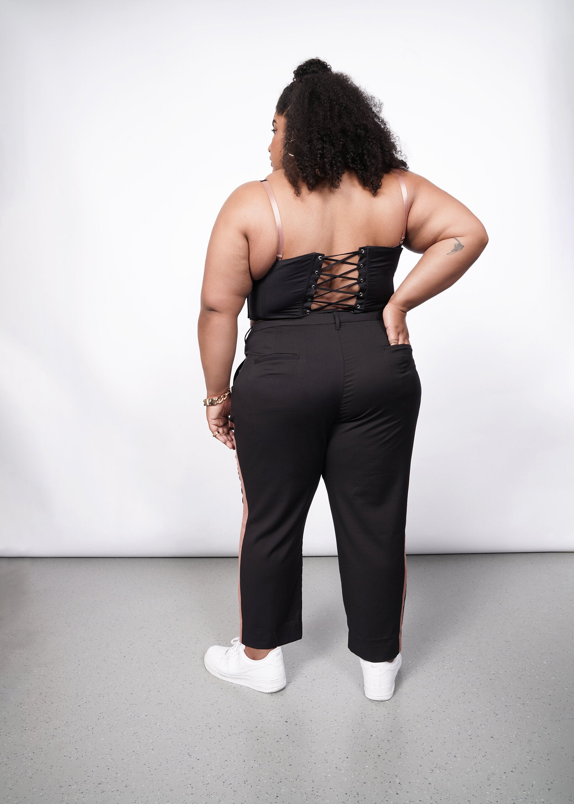 Model wearing The Empower Colorblock Slim Crop Pant in Black/Rose Brown