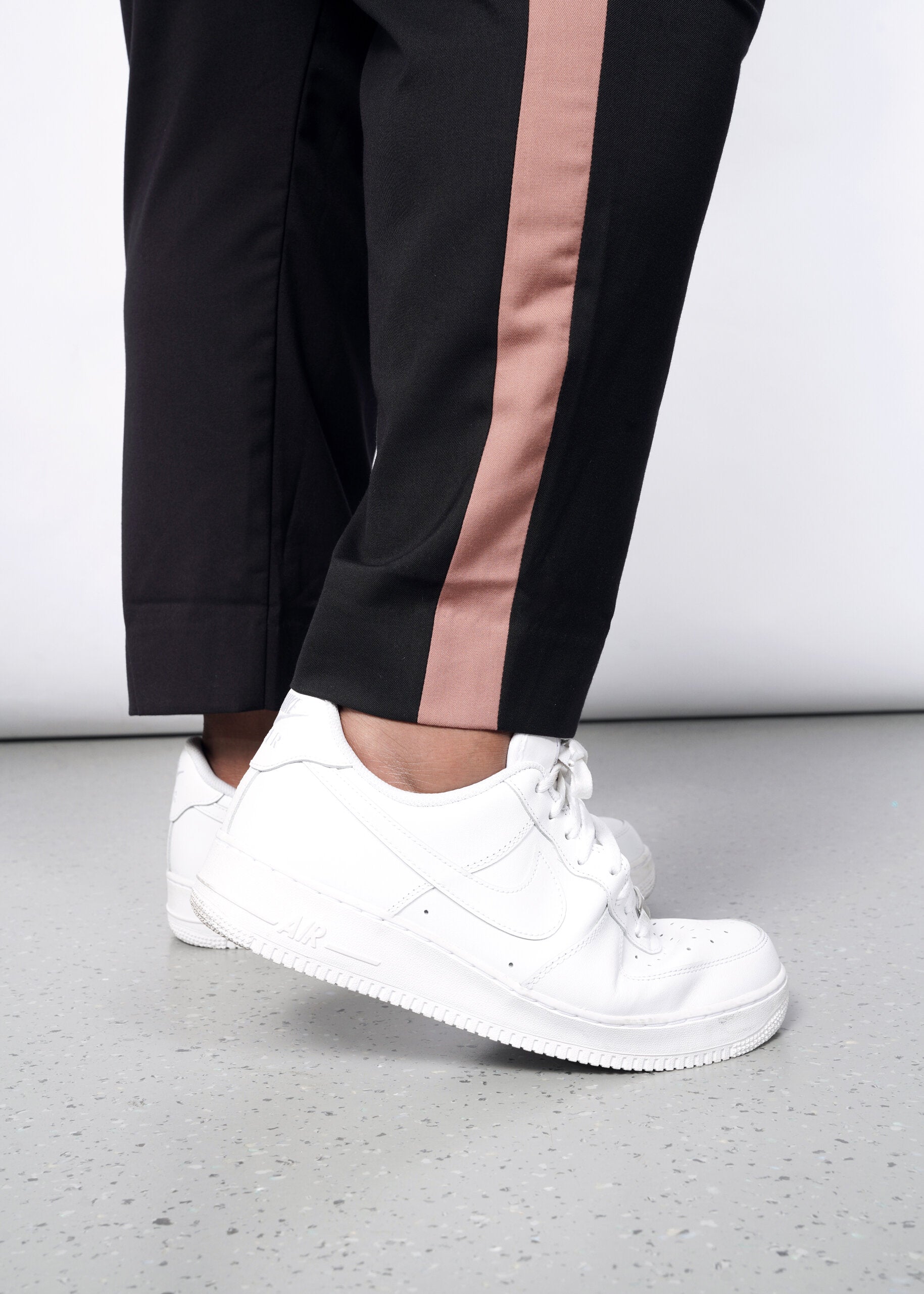Model wearing The Empower Colorblock Slim Crop Pant in Black/Rose Brown