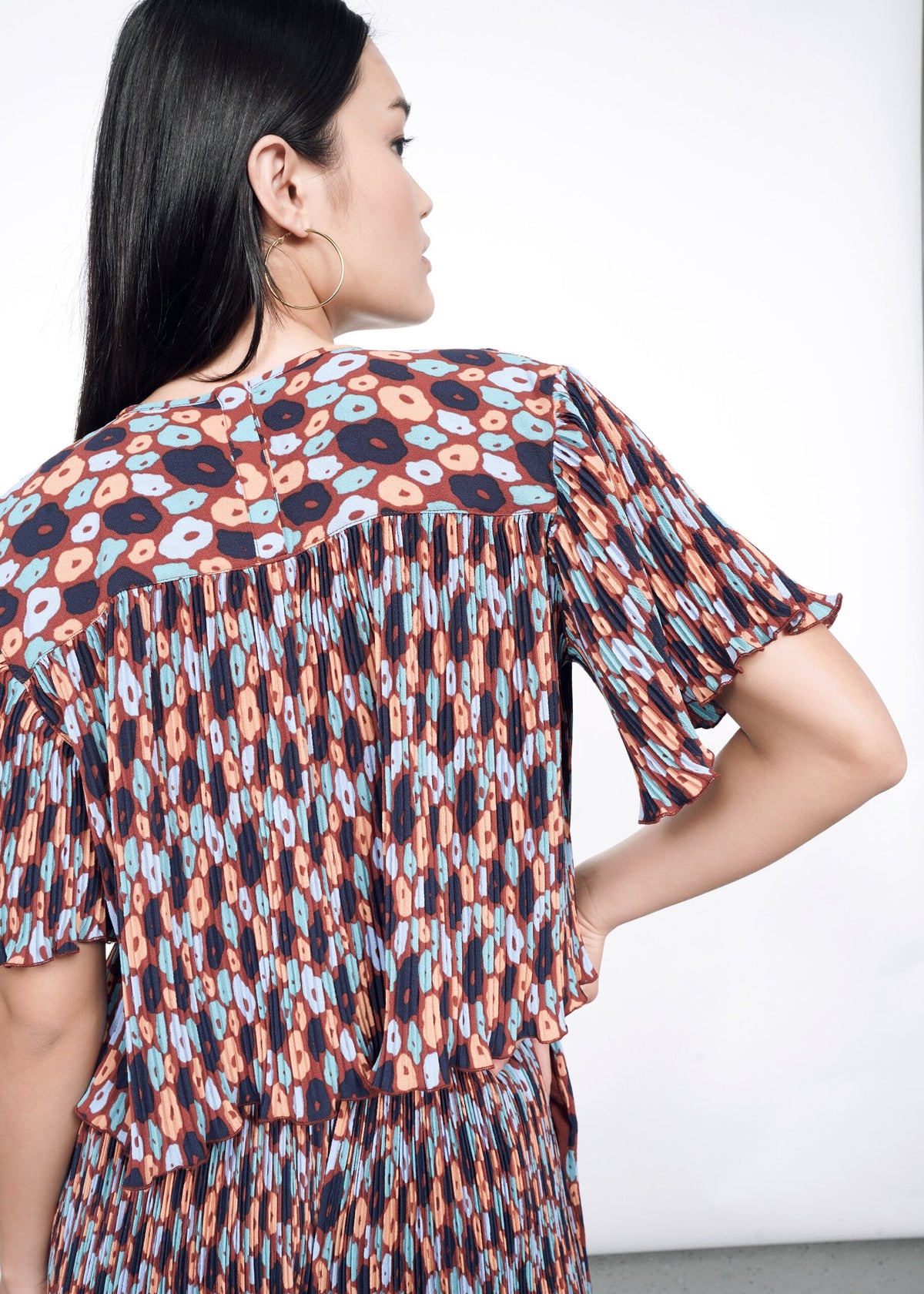 Back shot of The Empower Plisse Boxy Blouse