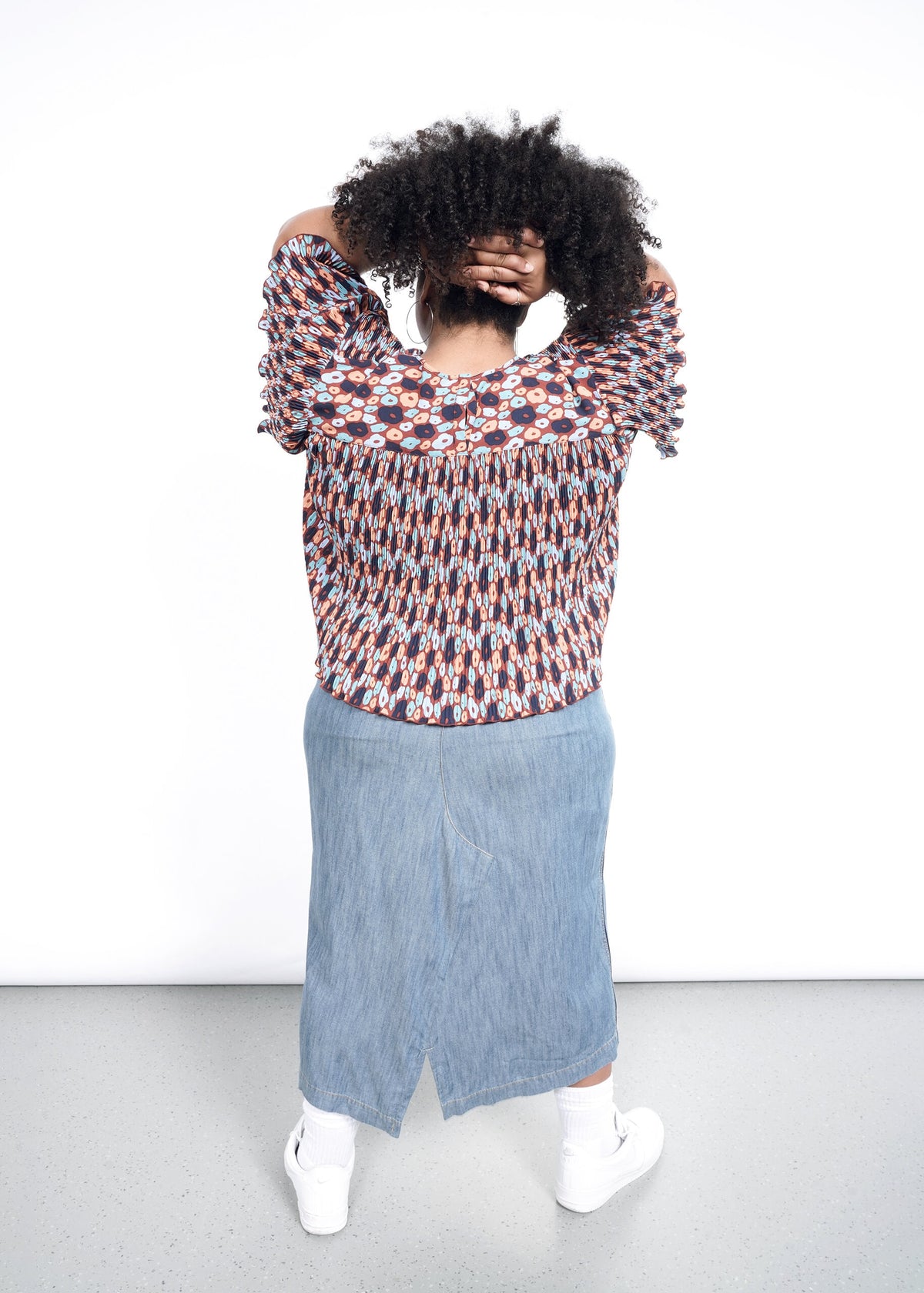 Back shot of The Empower Plisse Boxy Blouse