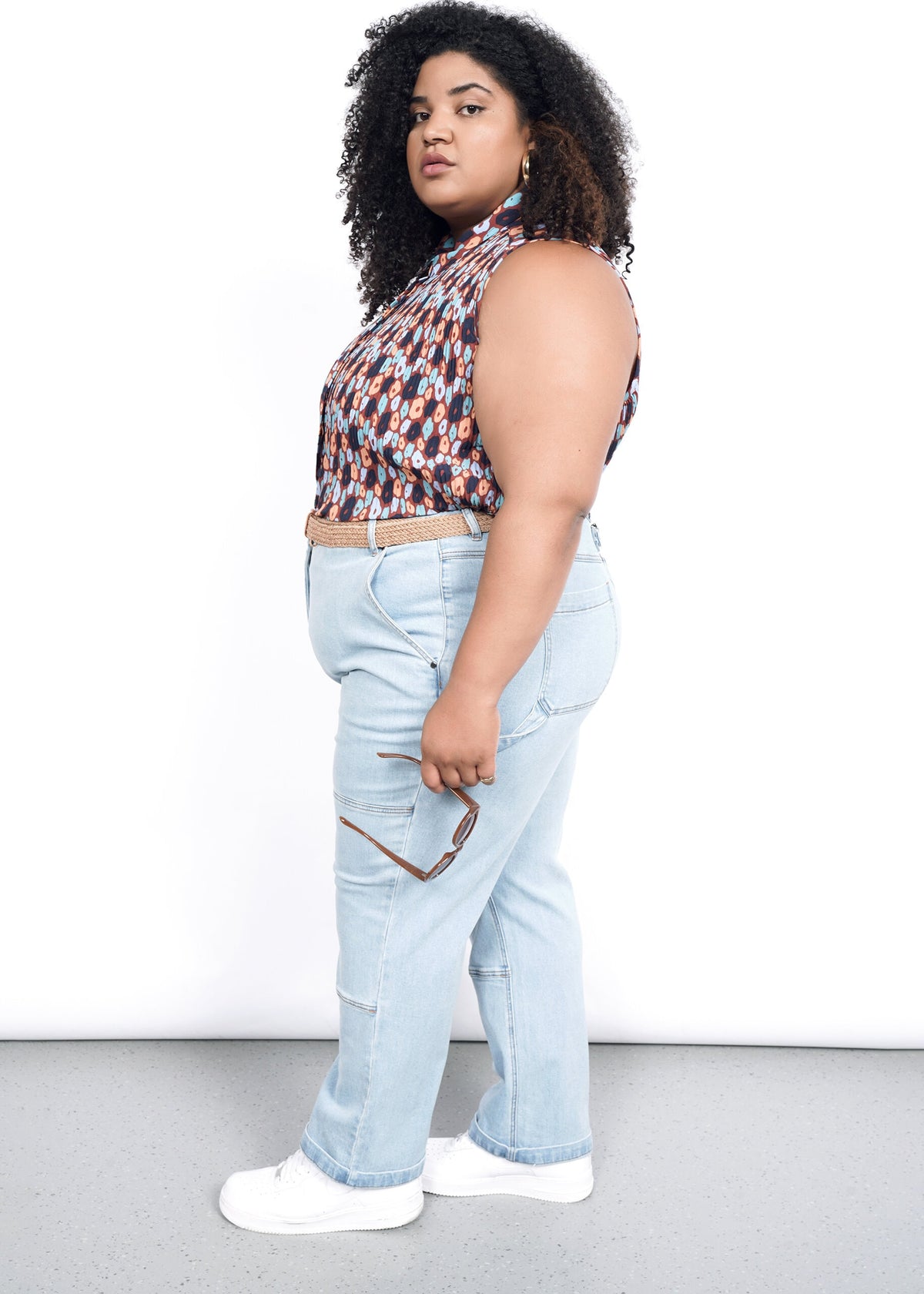 Side shot of The Empower Plisse Sleeveless Button Up