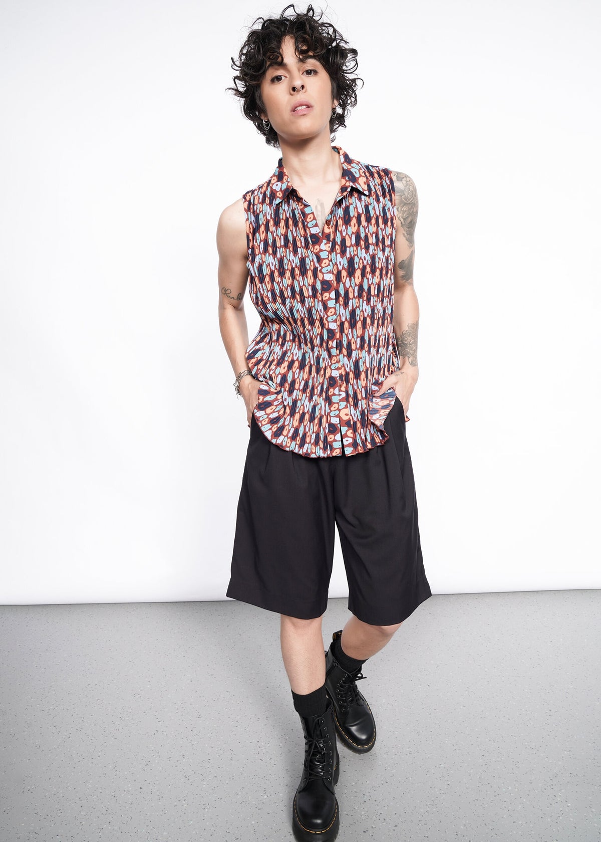 Model wearing The Empower Plisse Sleeveless Button Up
