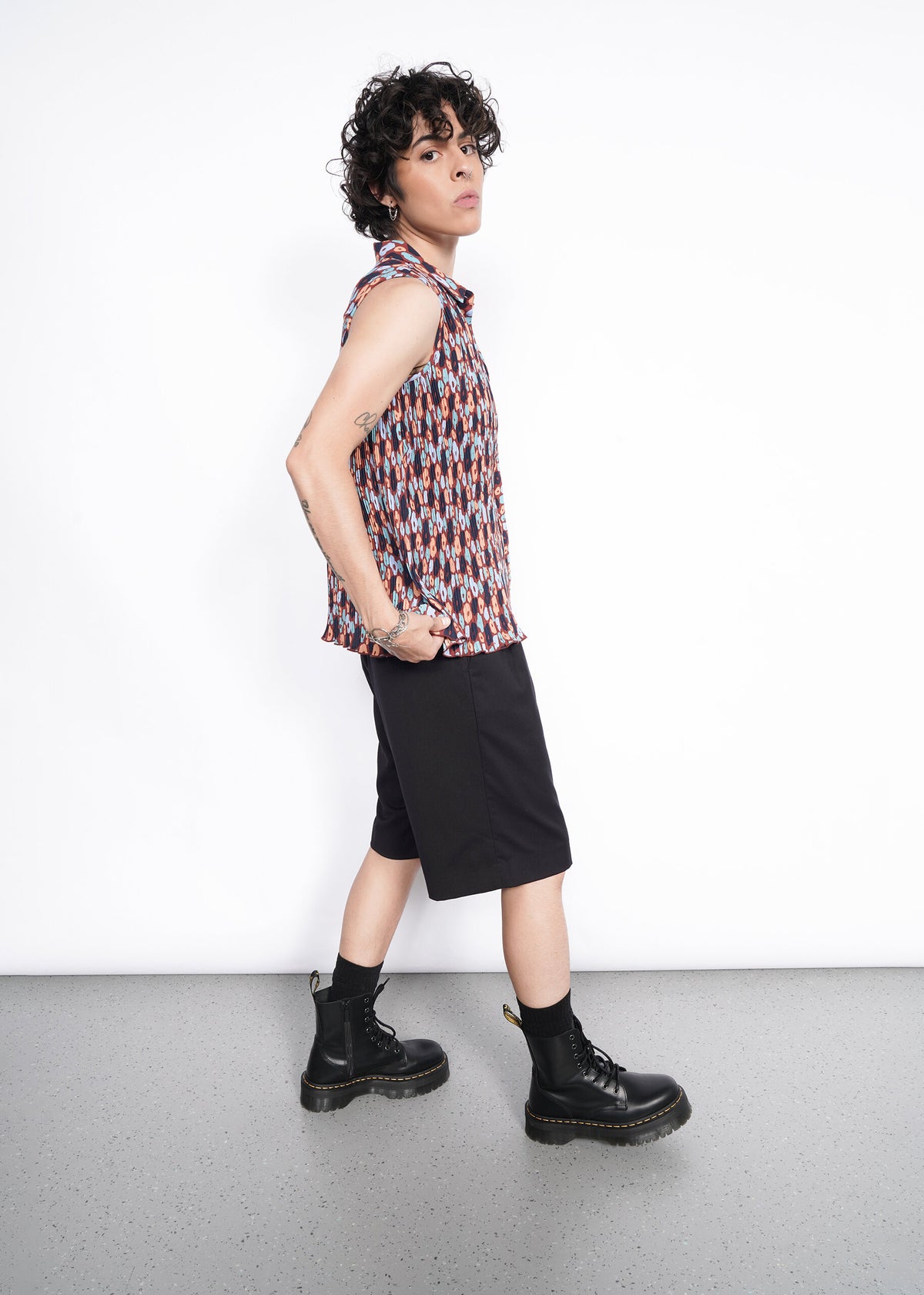 Side shot of The Empower Plisse Sleeveless Button Up