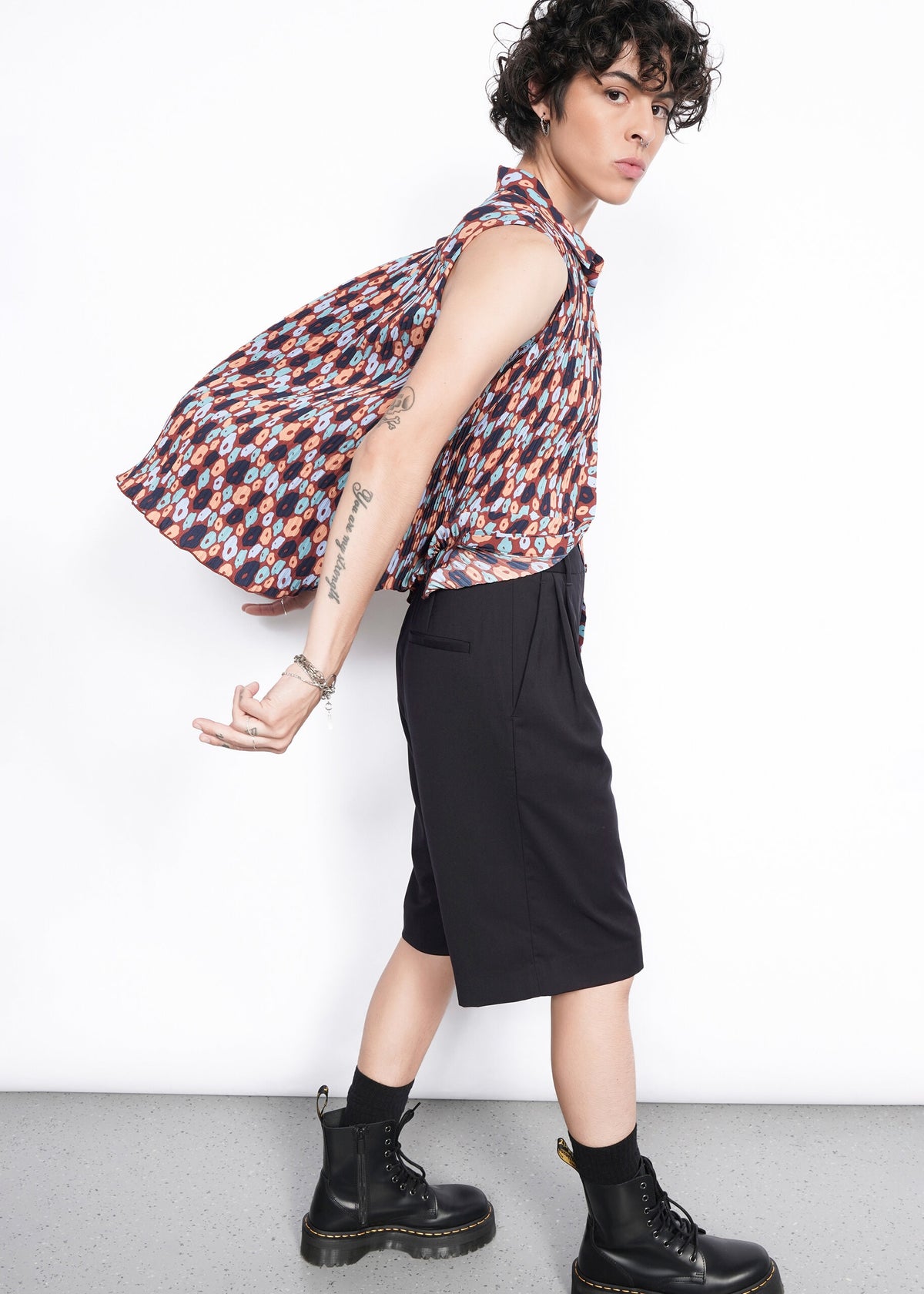 Side shot of The Empower Plisse Sleeveless Button Up
