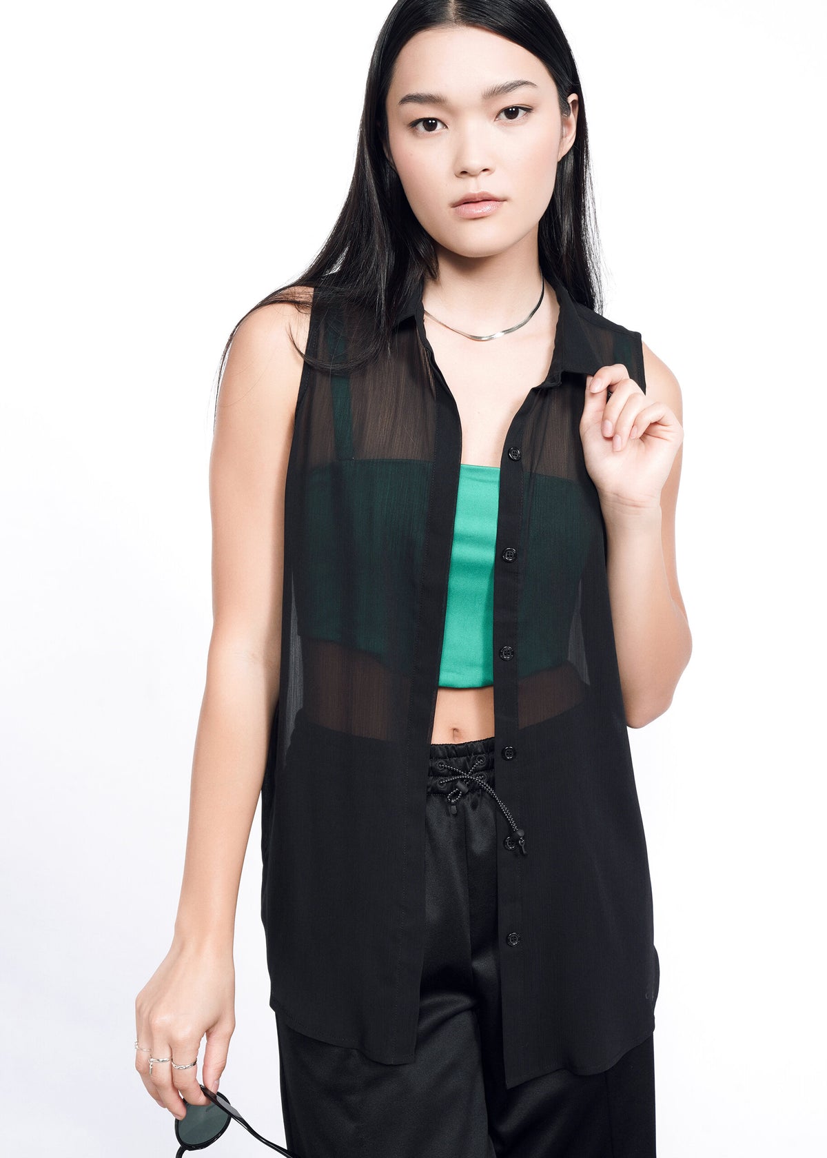 Model wearing The Empower Sheer Sleeveless Button Up in Black