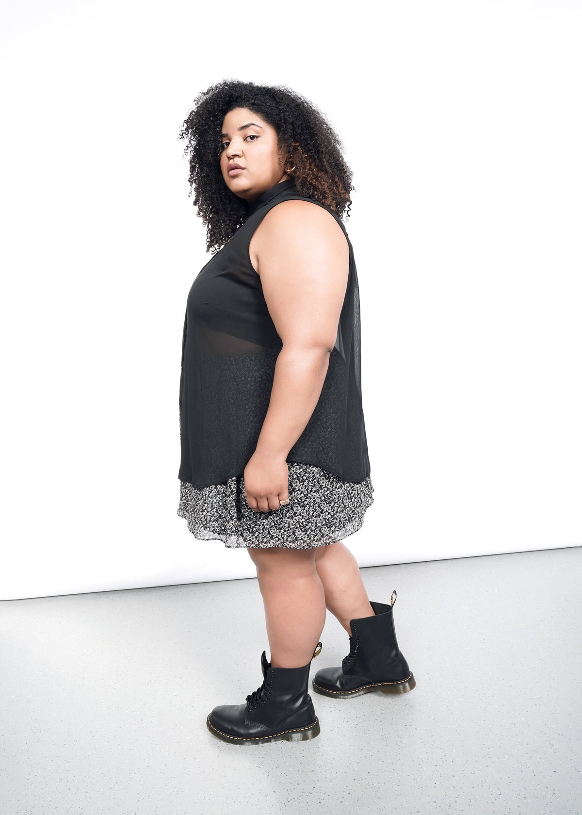 Side shot of The Empower Sheer Sleeveless Button Up in Black