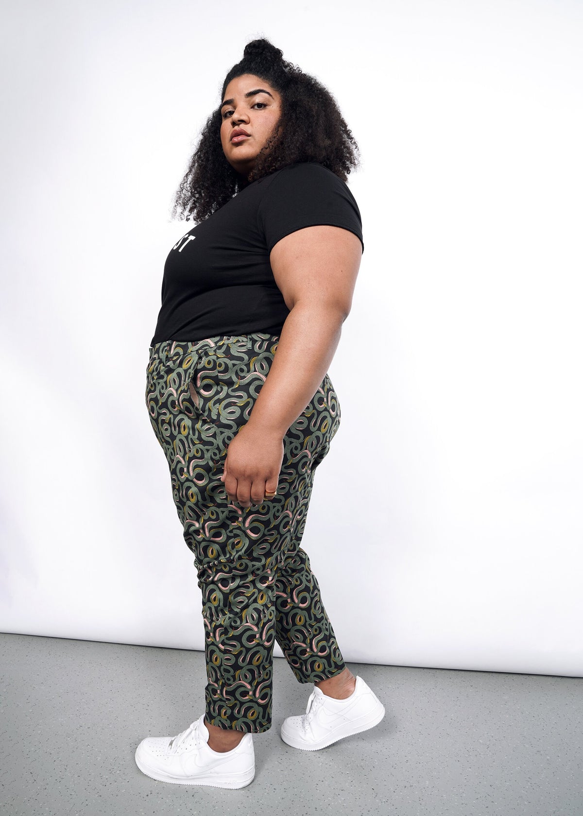 Model wearing The Empower Slim Crop Pant in Serpentine Black