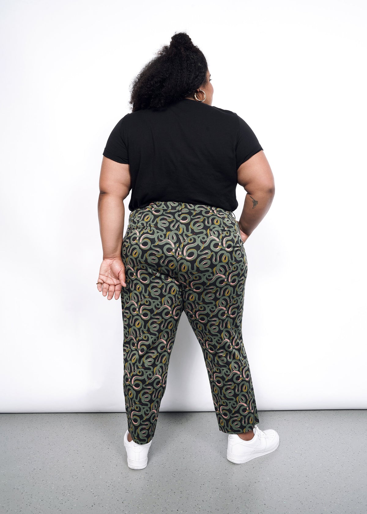 Model wearing The Empower Slim Crop Pant in Serpentine Black