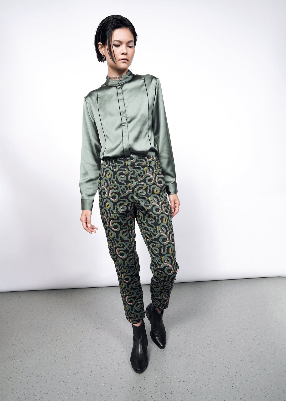 Model wearing The Empower Slim Crop Pant in Serpentine Black