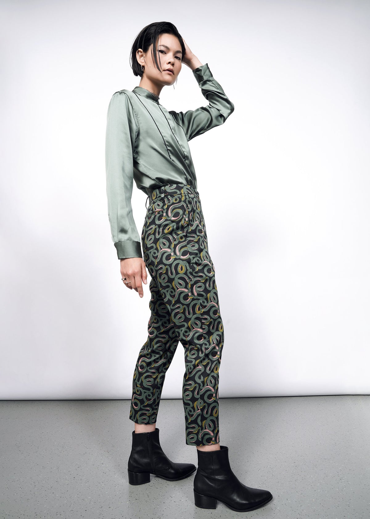 Model wearing The Empower Slim Crop Pant in Serpentine Black