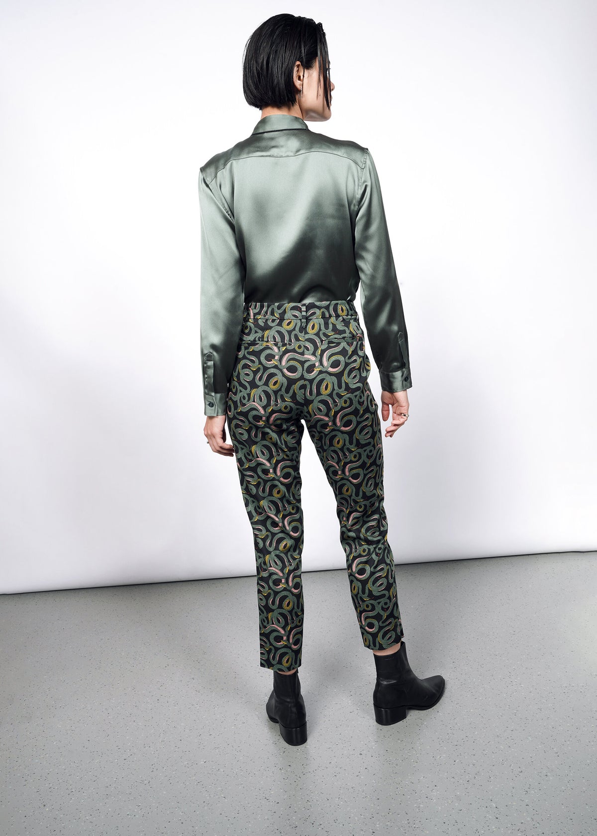 Model wearing The Empower Slim Crop Pant in Serpentine Black