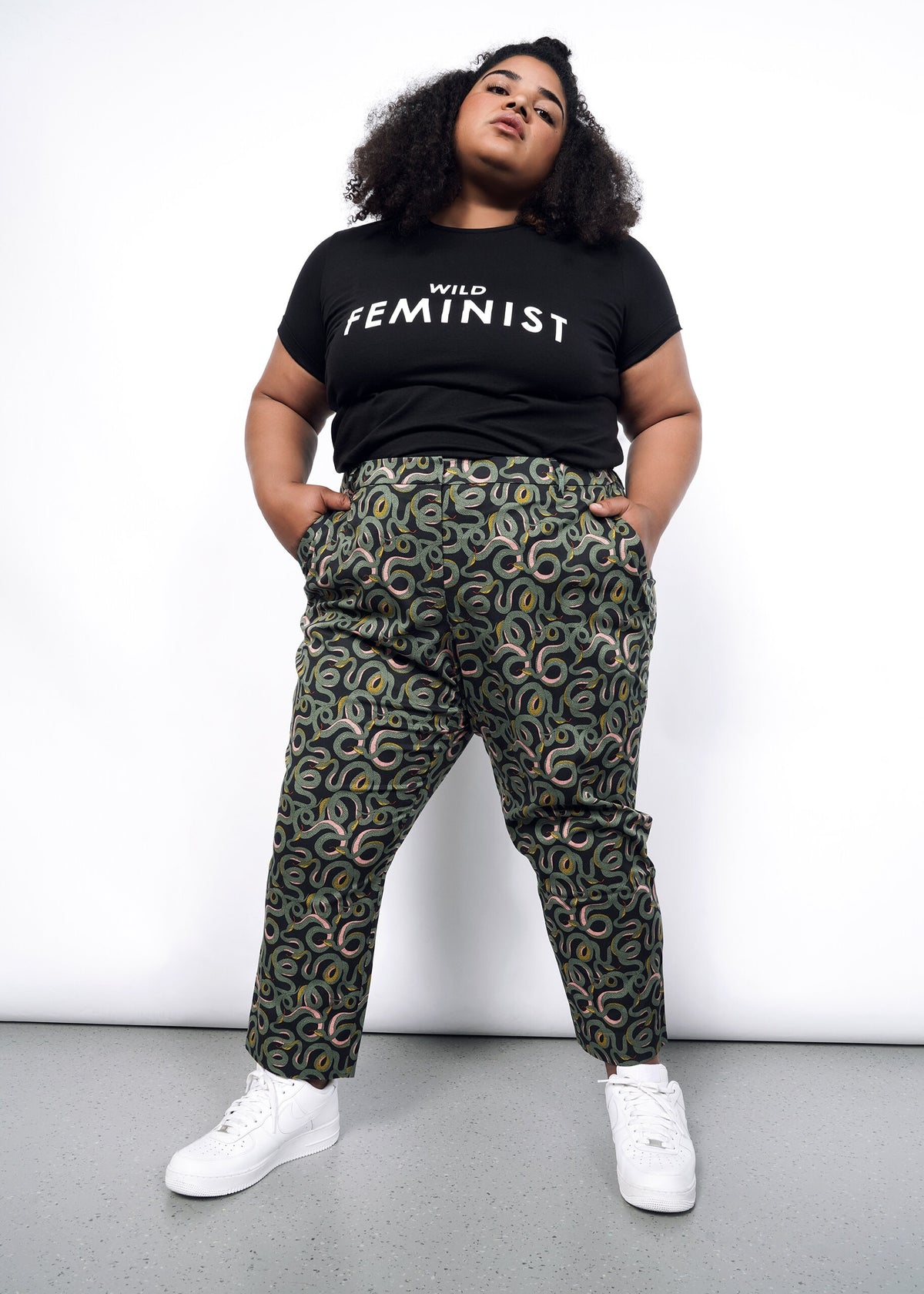 Model wearing The Empower Slim Crop Pant in Serpentine Black