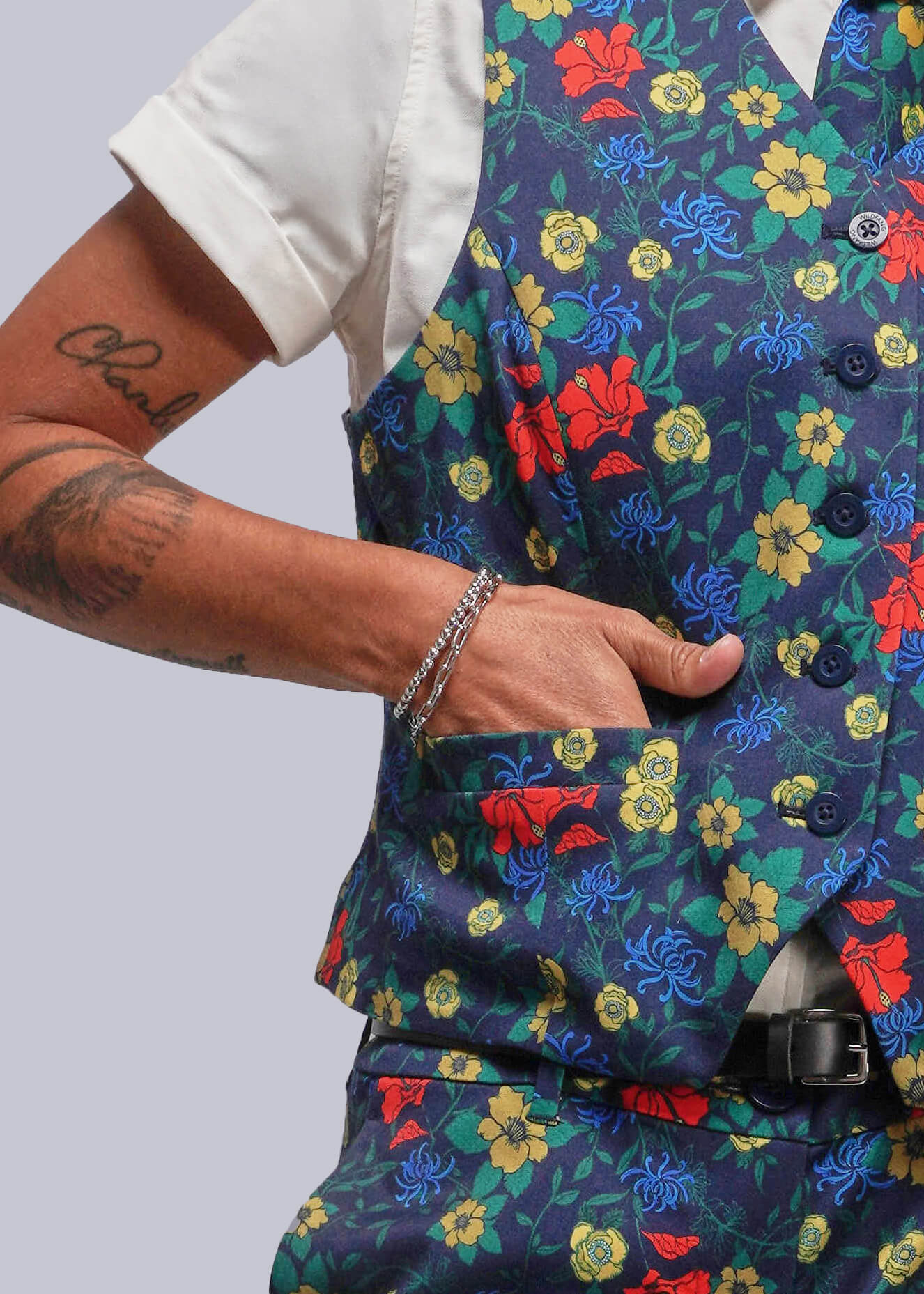 Colorful floral-patterned vest worn by a person on a plain background