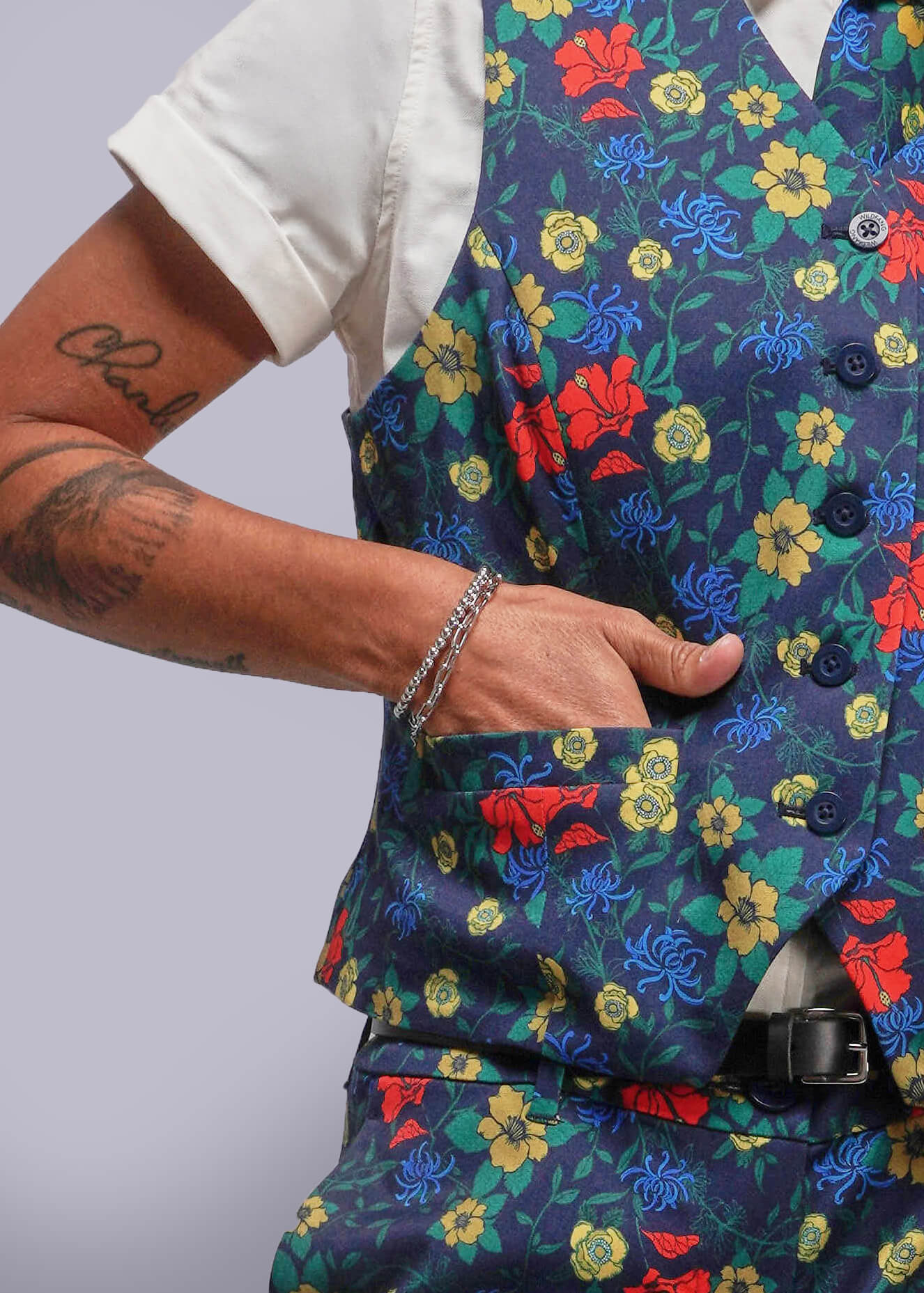 S=Colorful floral-patterned vest worn by a person on a plain background