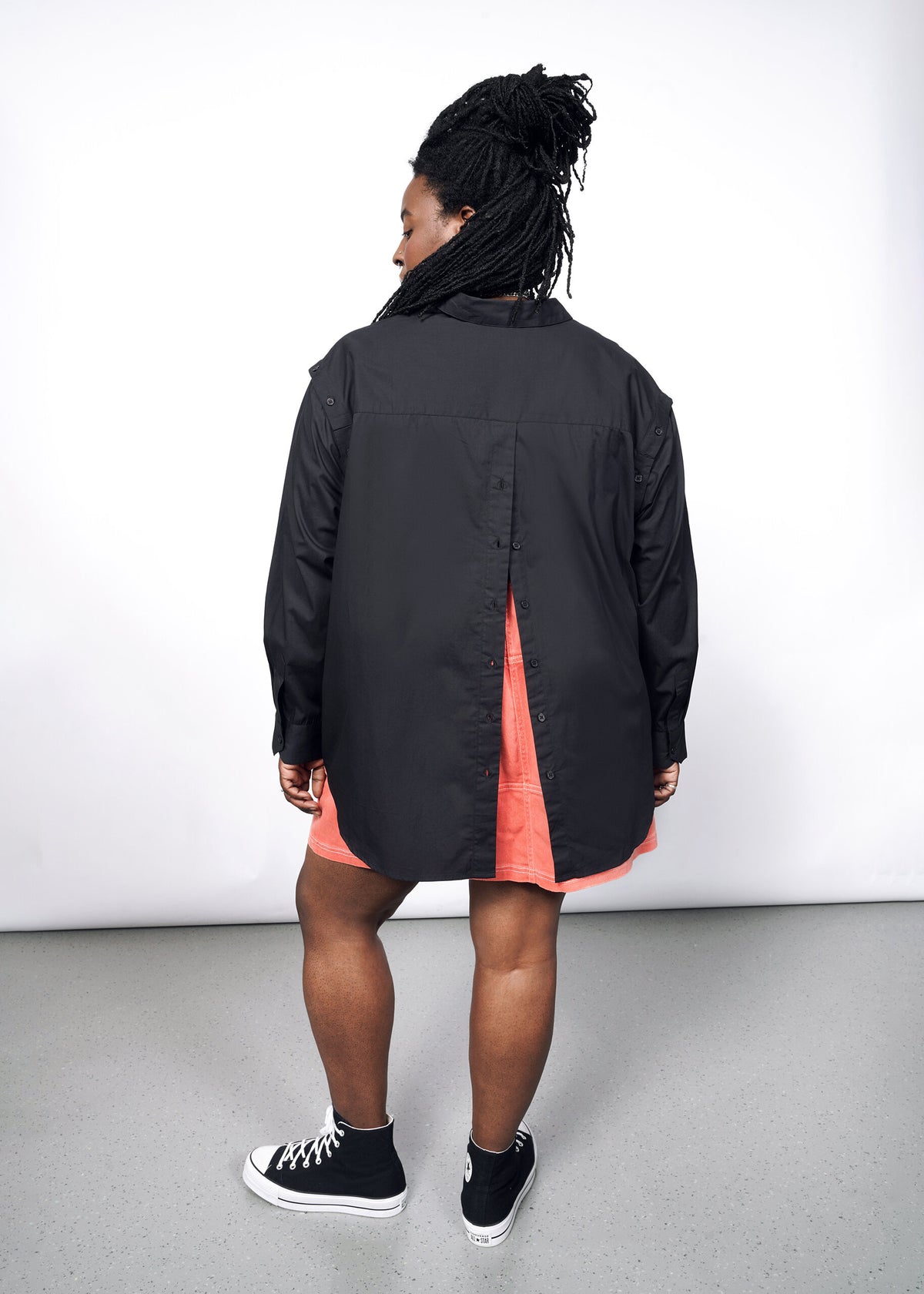 Model wearing The Essential 12-Way Button Up in Black