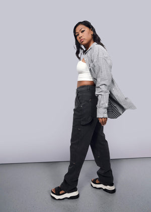 S=Model wearing The Essential Gingham Long Sleeve Oversized Convertible Button Up in Stripe Navy