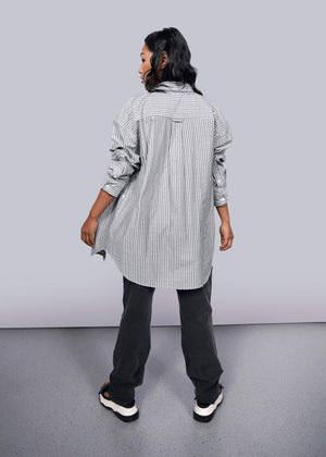 S=Model wearing The Essential Gingham Long Sleeve Oversized Convertible Button Up in Stripe Navy