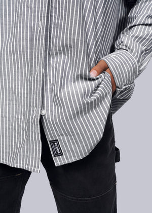 S=Model wearing The Essential Gingham Long Sleeve Oversized Convertible Button Up in Stripe Navy