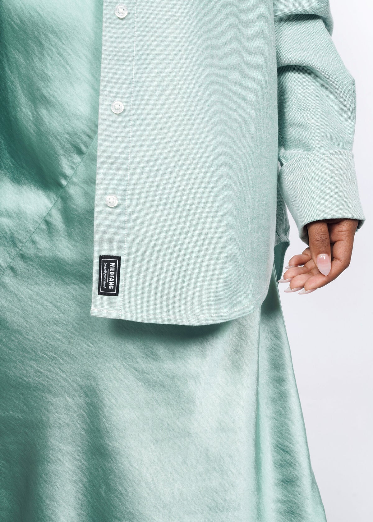 Model wearing The Essential Long Sleeve Oversized Convertible Oxford Button Up in Emerald/White