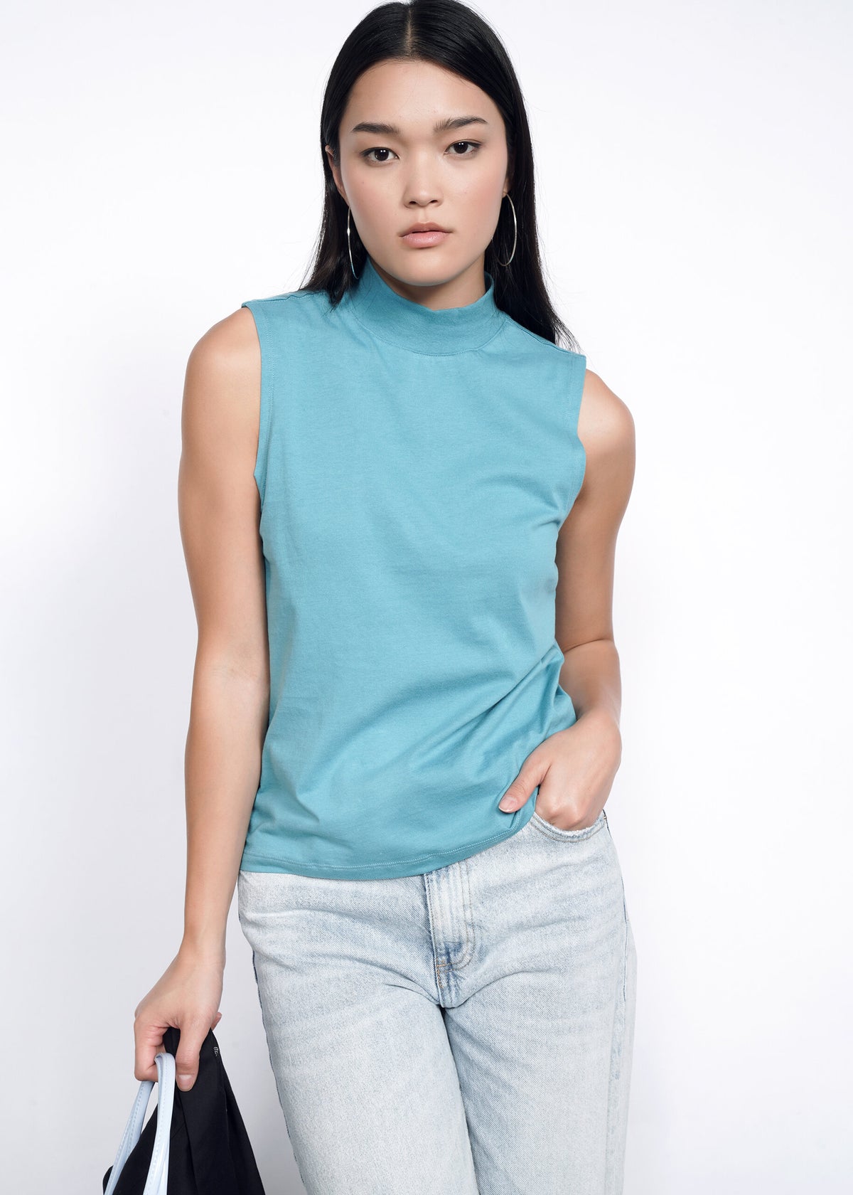 Model wearing The Essential Mock Neck Tank in Coastal
