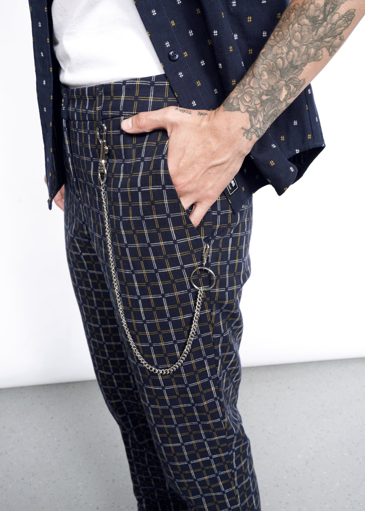 Model wearing The Essential Trouser in Grid Navy