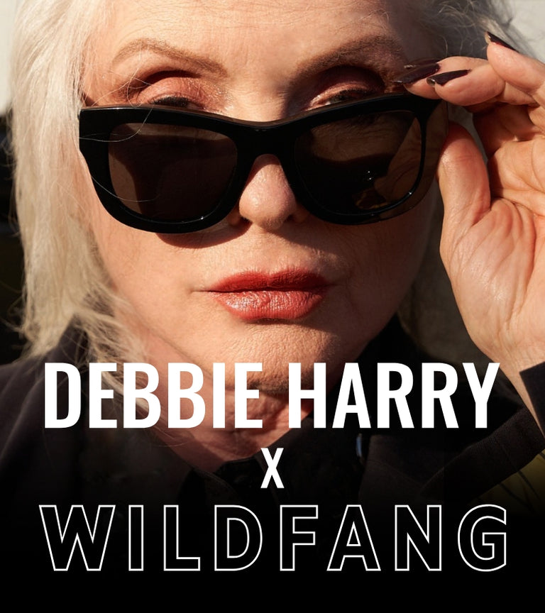 Close up image of Debbie Harry wearing black sunglasses with white text overlay that reads DEBBIE HARRY X WILDFANG