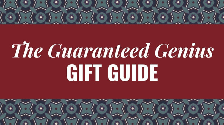 A graphic banner with the text 'The Guaranteed Genius GIFT GUIDE' in white serif lettering on a dark red background, framed by decorative geometric borders in teal, navy, and white.