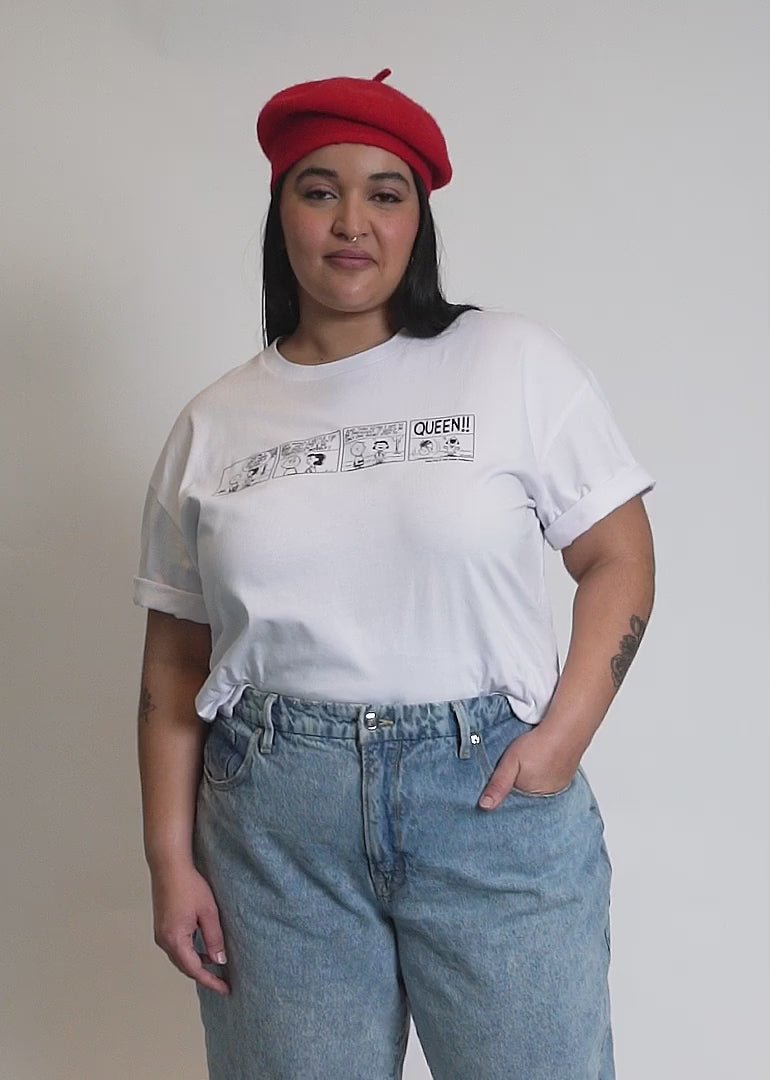 Video of two models of different sizes wearing The Peanuts x Wilfang Queen Comic Tee. Shows close up of Peanuts comic on tee, the short sleeve, and the comfortable white fabric.
