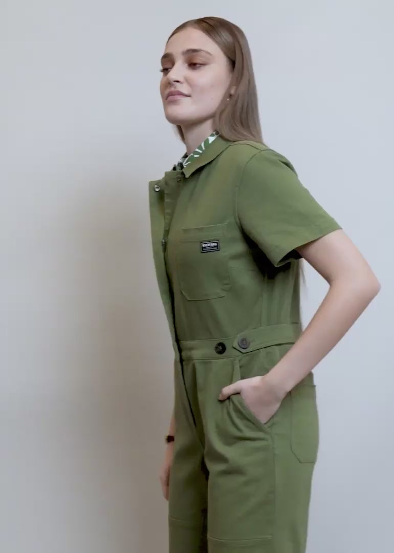 Model showing fit and features of The Essential Denim High Waisted Coverall in Moss Green.