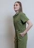 Model showing fit and features of The Essential Denim High Waisted Coverall in Moss Green.
