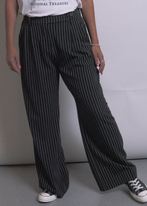 Two models of different sizes showcase the fit and features of The Empower Pinstripe Wide Leg Pant