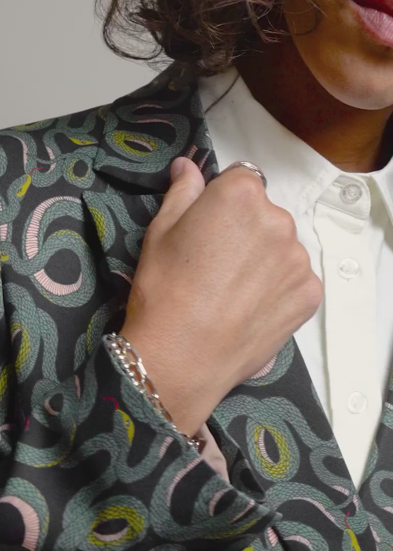 Video showing The Empower Double Breasted Blazer in snake Serpentine print.Video shows product on 3 different sized models showcasing each unique feature of the product including double breasted closure, stretch, soft material, ad deep pockets.