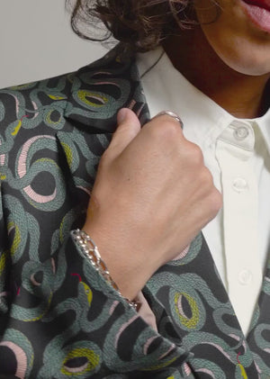 Video showing The Empower Double Breasted Blazer in snake Serpentine print.Video shows product on 3 different sized models showcasing each unique feature of the product including double breasted closure, stretch, soft material, ad deep pockets.