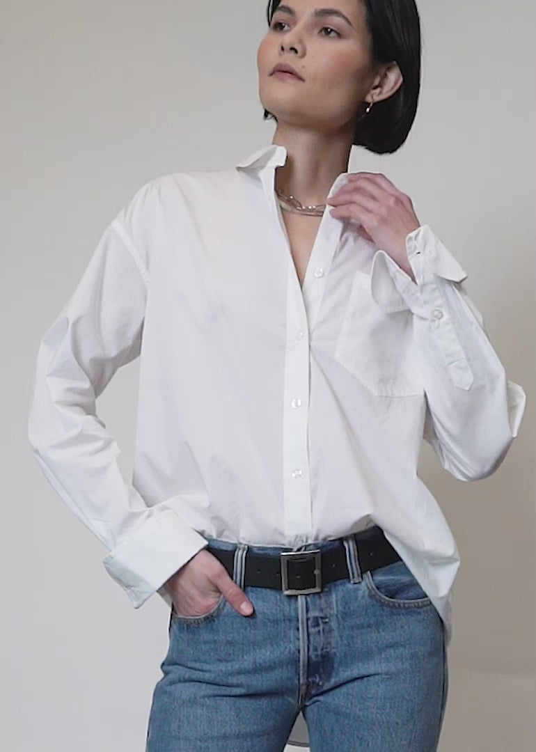 Video shows models of two different sizes wearing The Essential Long Sleeve Oversized Wrap Button Up. Video features close ups of the wrappable details, the buttons, the sleeve and cuffs.