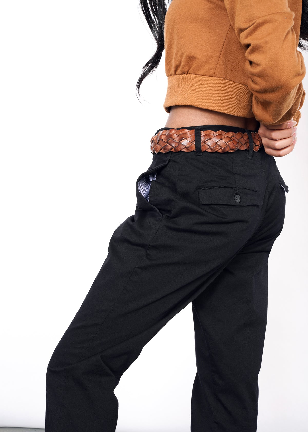 Back view of model wearing black essential trouser in size 2, showing interior lining in pocket and button flap back pockets